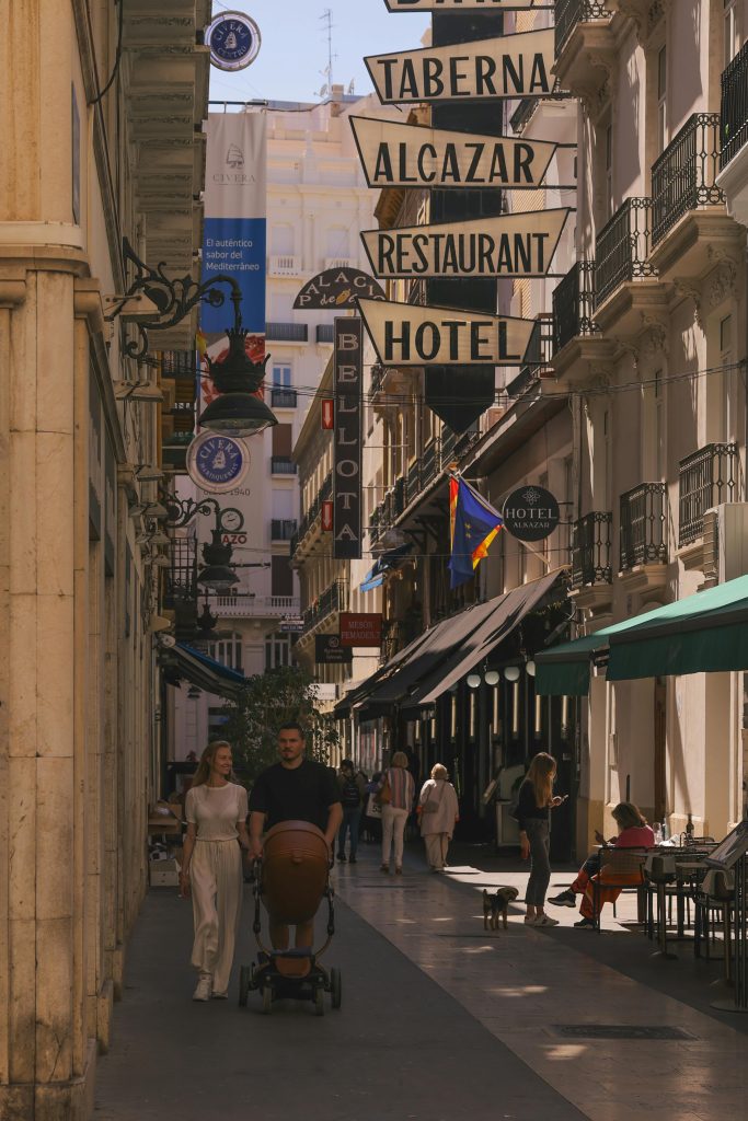 Charming street scene in Valencia, Spain, showcasing historic architecture and bustling cafes.